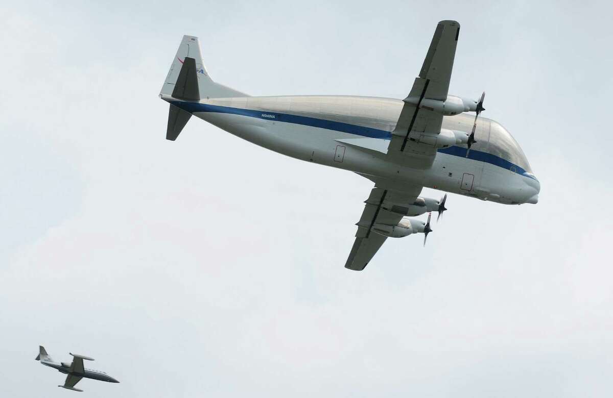 NASA's Super Guppy aircraft, carrying the Space Shuttle Trainer, flies by the Museum of Flight in Seattle with a chaser plane on Saturday, June 30, 2012. The rest of the Space Shuttle Trainer will be delivered to the museum in several stages over the next few months.