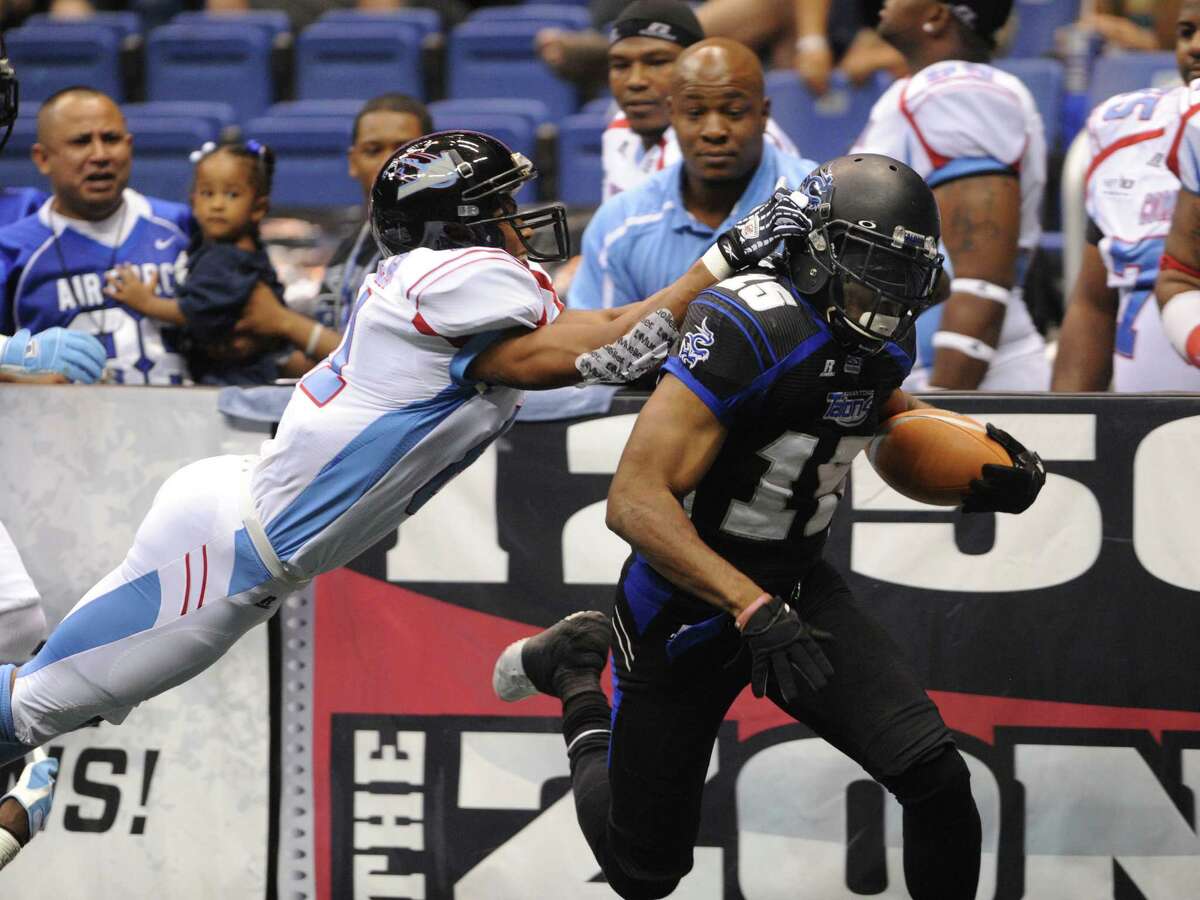 Kick returner Jomo Wilson of the San Antonio Talons scores on the opening kickoff as Kansas City Command defender Samie Parker chases during Arena Football League action in the Alamodome on Saturday, June, 30, 2012.