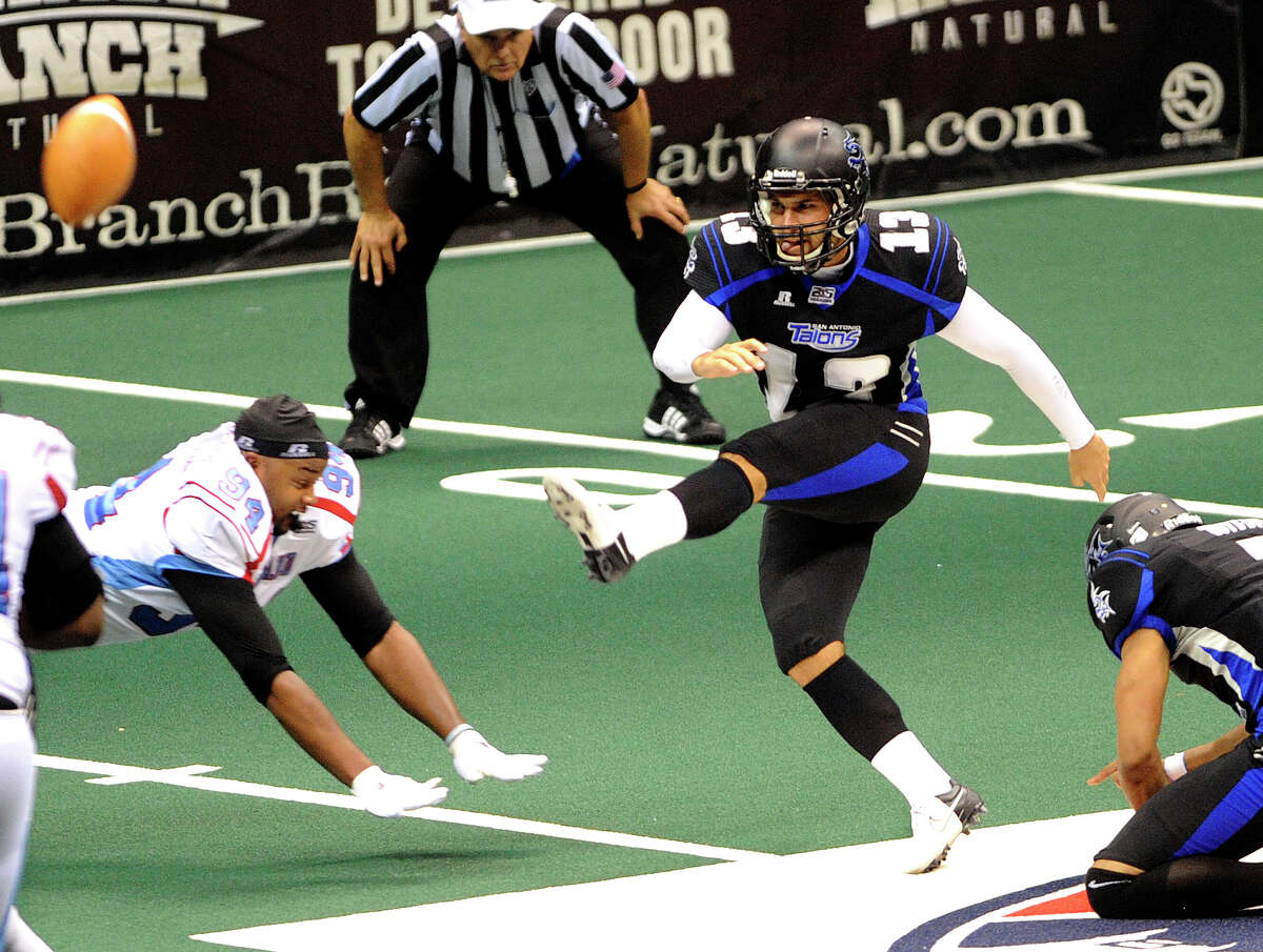 San Antonio Talons kicker Stefan Demos kicks a 33-yard field goal at the end of the first half as Mike Robinson of the Kansas City Command attempts to block it despite losing his helmet during Arena Football League action in the Alamodome on Saturday, June, 30, 2012.