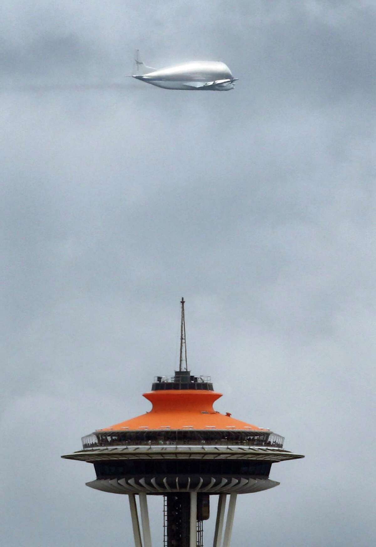 NASA's Super Guppy airplane flies over downtown Seattle on its way to Boeing Field and the Museum of Flight. The unique aircraft was carrying the crew compartment of NASA's Space Shuttle Full Fuselage Trainer, an artifact being donated to the museum.