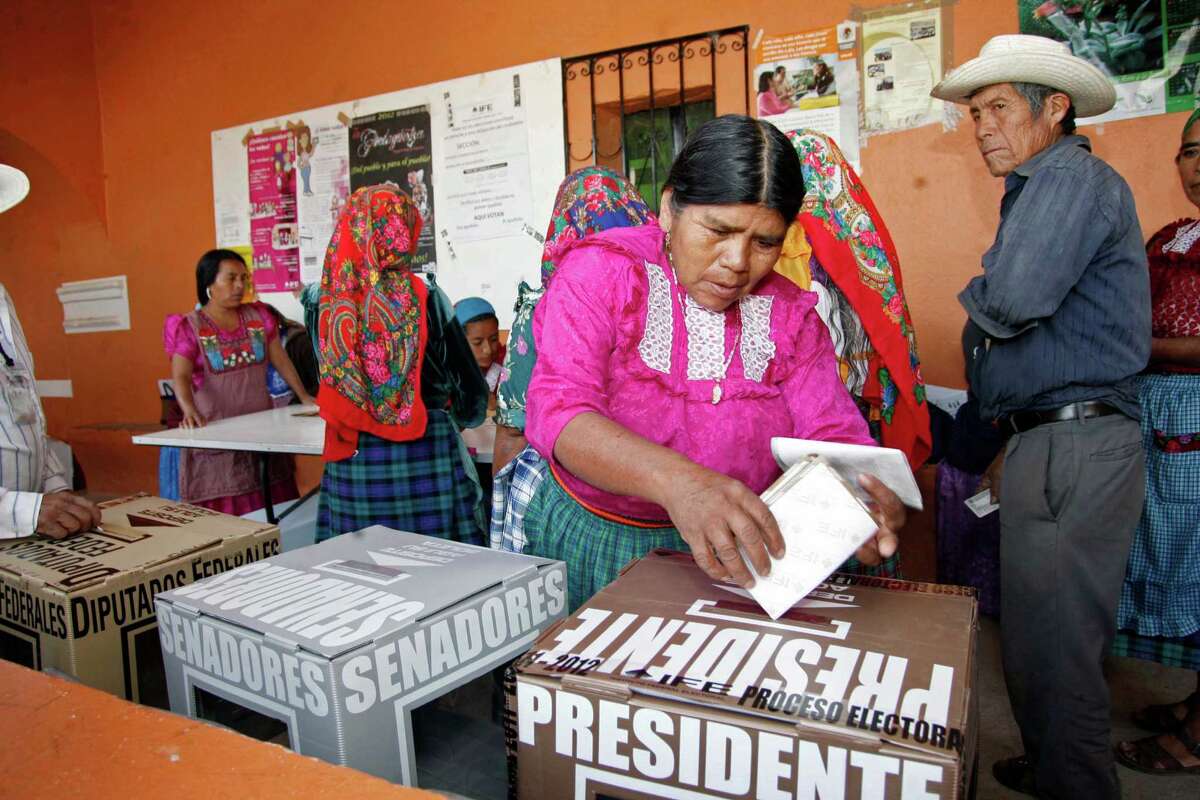 A woman casts her ballot at a polling station in Oaxaca, Mexico, Sunday, July 1, 2012. Mexico's more than 79 million voters head to the polls Sunday to elect a president, who serves one six-year term, as well as 500 congressional deputies and 128 senators.