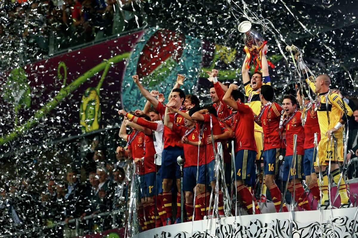 Spanish players celebrate with the trophy after defeating Italy 4-0 in the Euro 2012 soccer championship final in Kiev, Ukraine, Sunday, July 1, 2012.