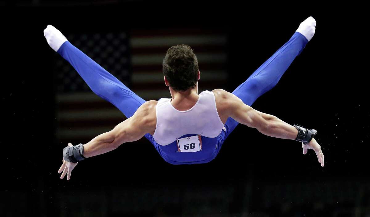 Alexander Naddour competes on the parallel bars during the preliminary round of the men's Olympic gymnastics trials Thursday, June 28, 2012, in San Jose, Calif. (AP Photo/Gregory Bull)