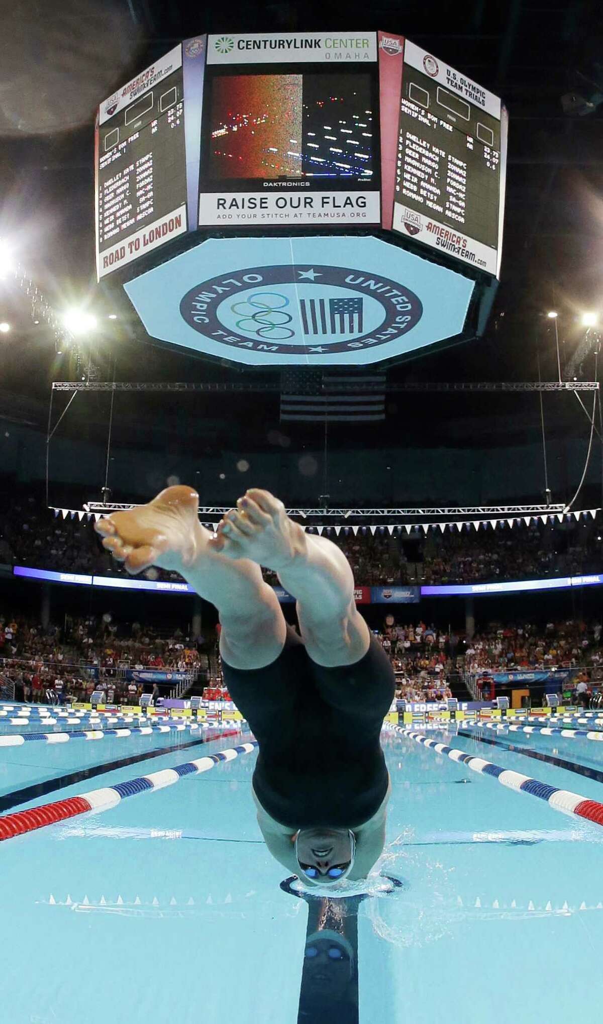 Madison Kennedy dives at the start of the women's 50-meter freestyle semifinal at the U.S. Olympic swimming trials on Sunday, July 1, 2012, in Omaha, Neb. (AP Photo/Mark Humphrey)