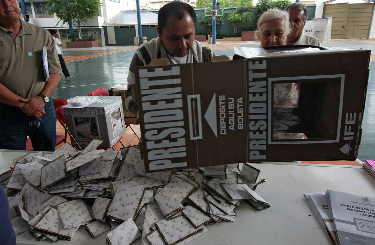 Officials open a ballot box to start counting votes in Guadalajara, Mexico, on Sunday. Officials said reports of irregularities were down 50 percent from 2006.
