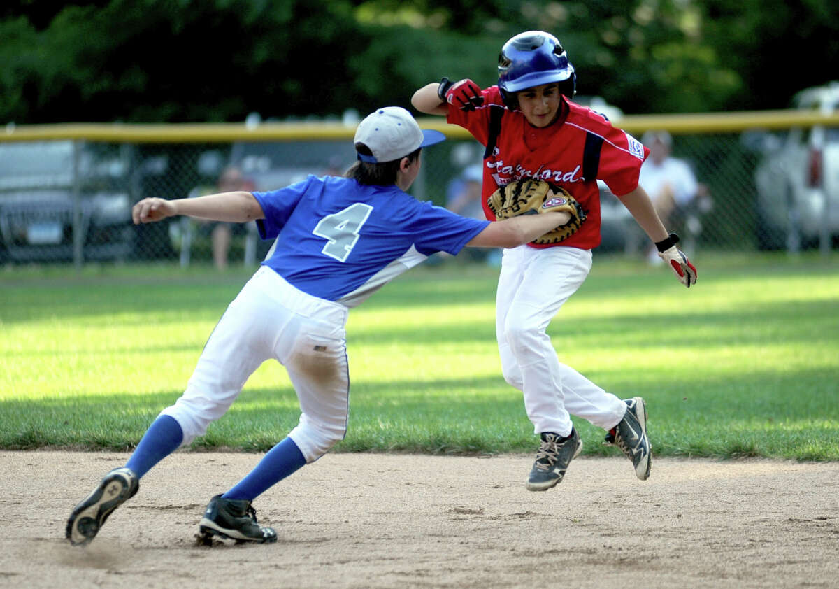 Stamford's Mark Raimondi is tagged out by Darien's Ethan Ehlers during Friday's Little League game at McGuane Field in Darien on June 29, 2012.