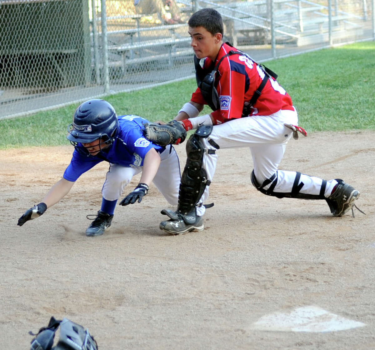 Stamford's Danny Collazo tags Darien's Justin Van de Graaf out near home plate during Friday's Little League game at McGuane Field in Darien on June 29, 2012.