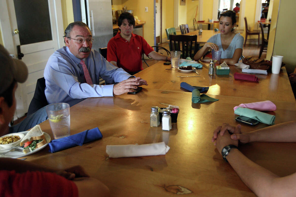 Newly elected Texas State Democratic Chairman Gilberto Hinojosa, left, meets with committee members of the Bexar County Young Democrats at Madhatters Tea House & Cafe, Wednesday, June 27, 2012. Members include Dante Small, president, center, and Sarah Gibbens, (cq), secretary.