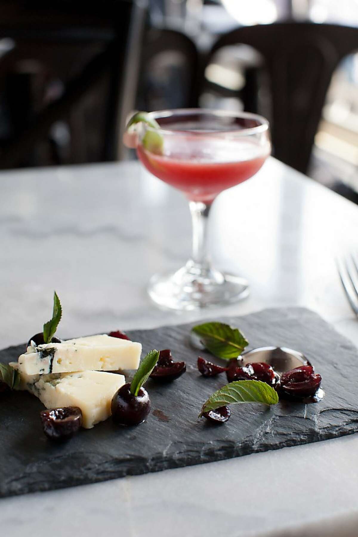 Park Tavern restaurant's new "Three Martini lunch and Summer Fridays" program features three courses, each paired with a martini-type drink, small in size so guests can indulge. Here, a dessert of Rogue Creamery blue cheese with smoked bing cherries, chocolate mint sauce and walnut bread is paired with a sour cherry daiquiri.
