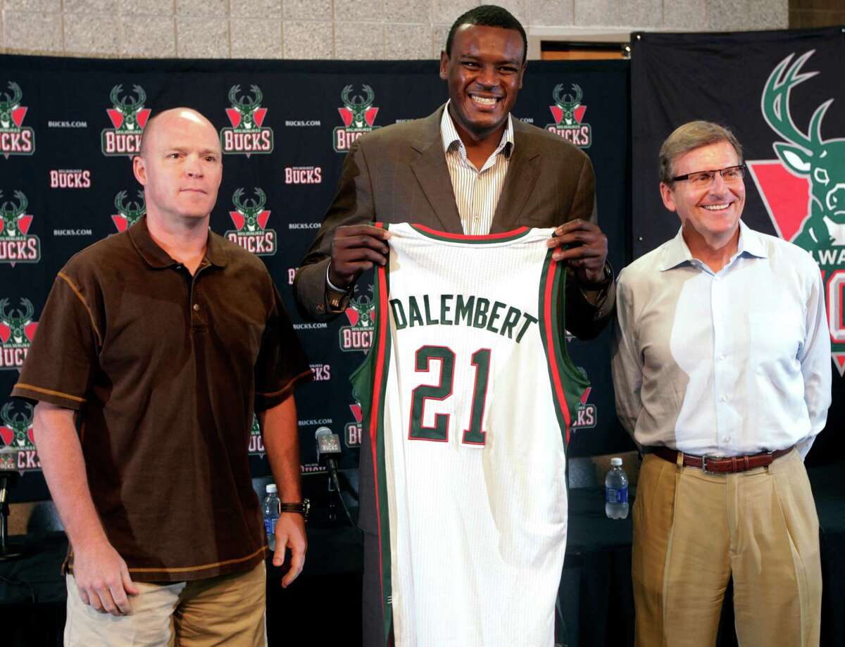 Newly acquired Milwaukee Bucks center Samuel Dalembert, center, poses with head coach Scott Skiles, left, and general manager John Hammond before an NBA basketball news conference, Monday, July 2, 2012, in Milwaukee. The Bucks traded Jon Leuer, Jon Brockman and Shaun Livingston to the Houston Rockets to get Dalembert, and the two teams also traded draft picks, which Milwaukee used to get North Carolina forward John Henson. (AP Photo/Milwaukee Journal-Sentinel, Mark Hoffman) NO SALES; TV OUT; MAGS OUT