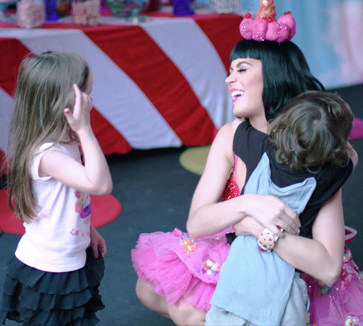 Katy Perry gets a hug from a young fan in a scene from the movie "Katy Perry: Part of Me."