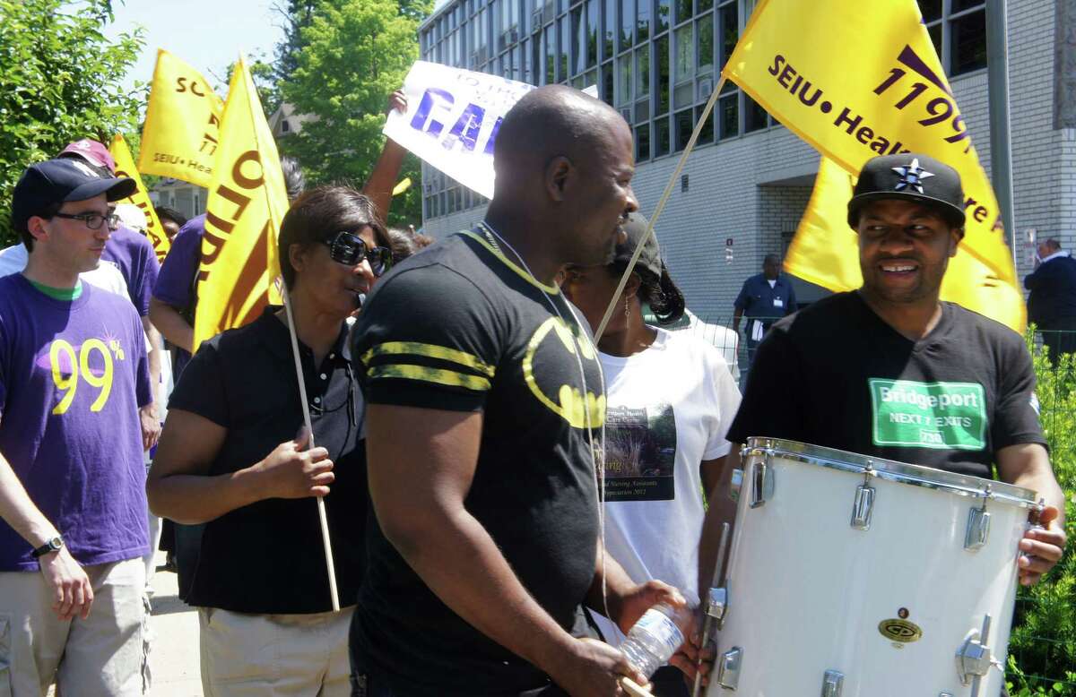 Striking union workers used drums and chants to rally picket lines Tuesday as New England Health Care Employees Union, District 1199, struck the Westport Health Care Center and four other state nursing homes owned by HealthBridge.