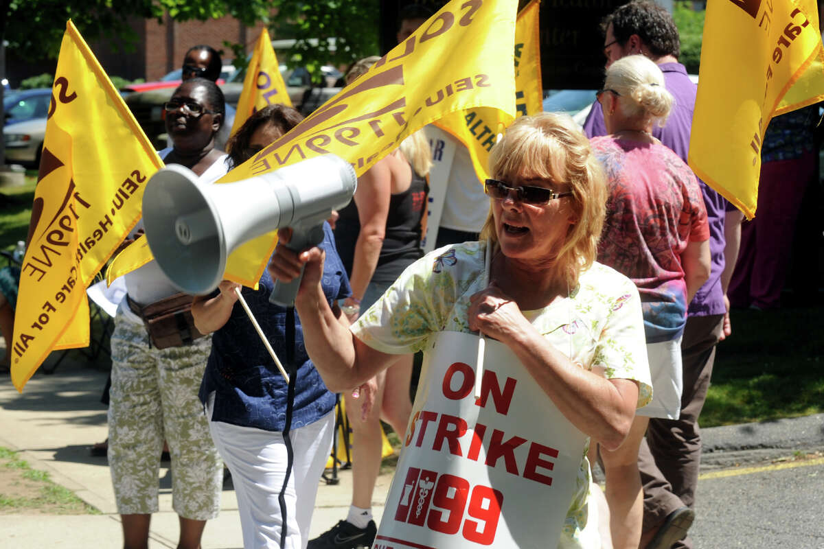 Cynthia Bain, of Milford, and other health care workers protest in front of West River Health Care Center, in Milford, Conn., July 3rd, 2012. Workers at five HealthBridge-owned nursing homes around the state went on strike Tuesday morning after the health care company declined to return to the bargaining table.