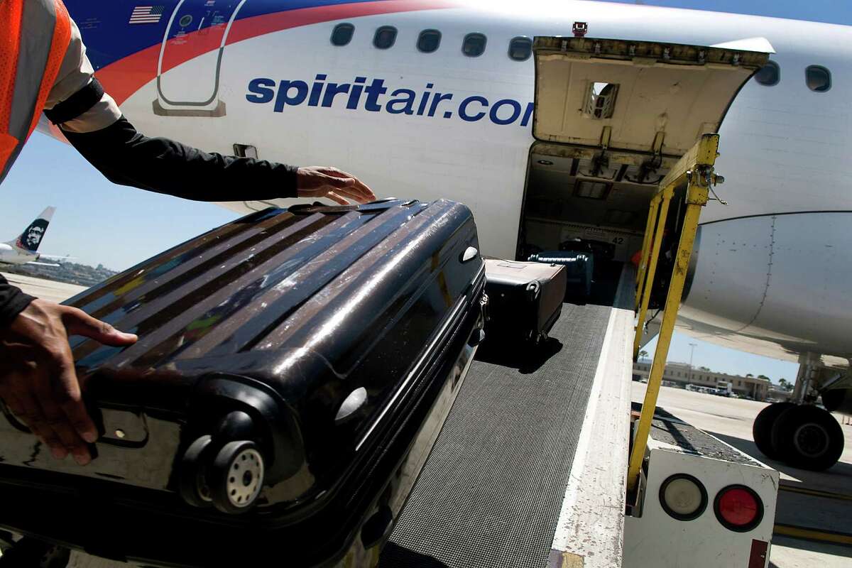 Baggage goes into a Spirit Airlines jetliner in San Diego. Spirit will have 22 routes from Houston in the spring.Photographer: Sam Hodgson/Bloomberg