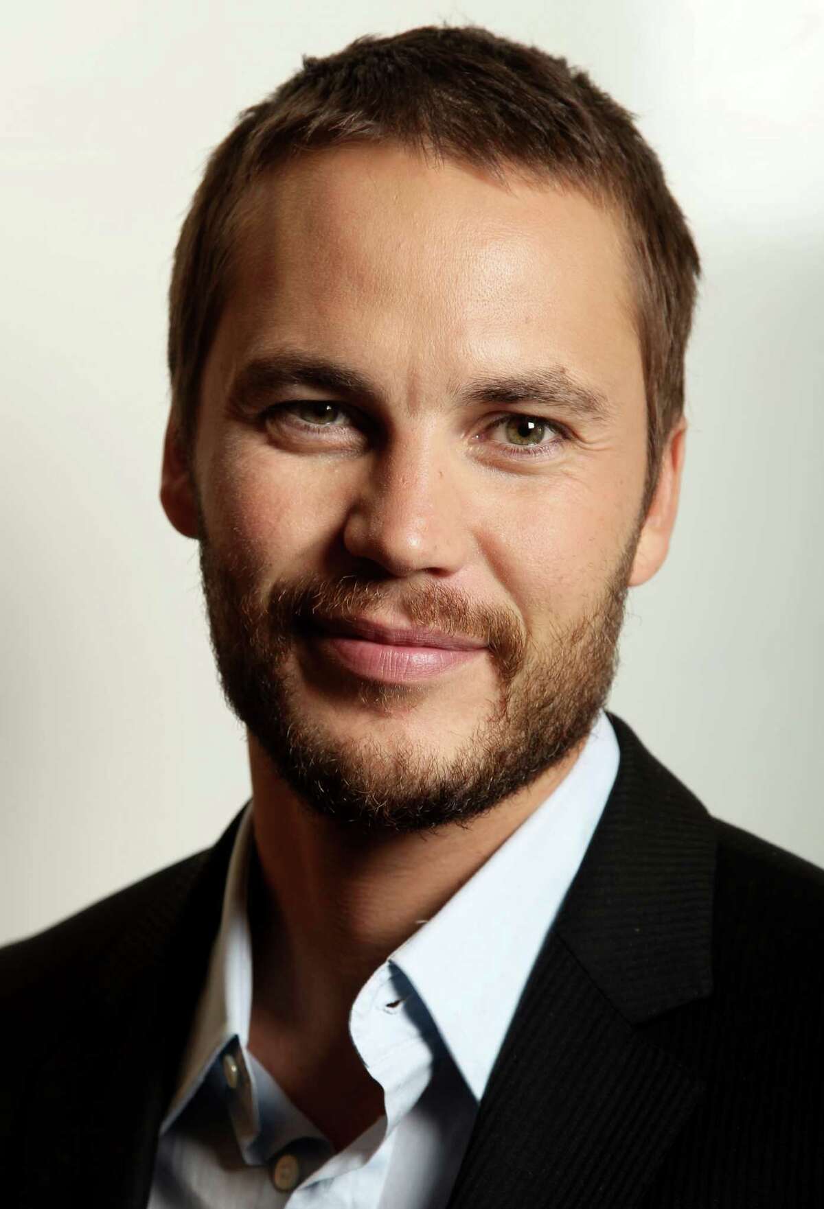In this Friday, June 15, 2012 photo, actor, Taylor Kitsch, who appears in Oliver Stone's new film "Savages," poses for a portrait in Beverly Hills, Calif. Kitsch plays a California marijuana dealer in the movie, along with actor, Aaron Johnson, battling a vicious Mexican cartel that aims to take over their business growing primo weed. (Photo by Matt Sayles/Invision/AP)