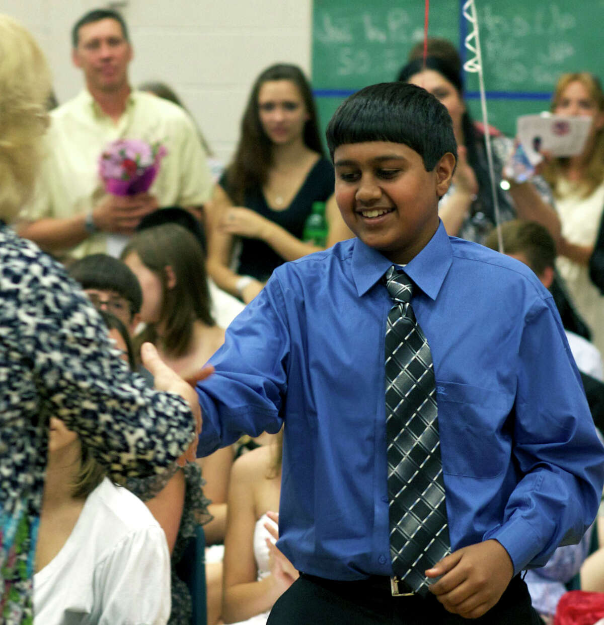 Aakash Parikh is justifiably all smiles as he collects awards including Outstanding Student in Science, Outstanding Achievement in Math, the Cabe Scholars and perfect attendance for five years during Team Red and Team Blue's promotion ceremony at Schaghticoke Middle School in New Milford. June 18, 2012