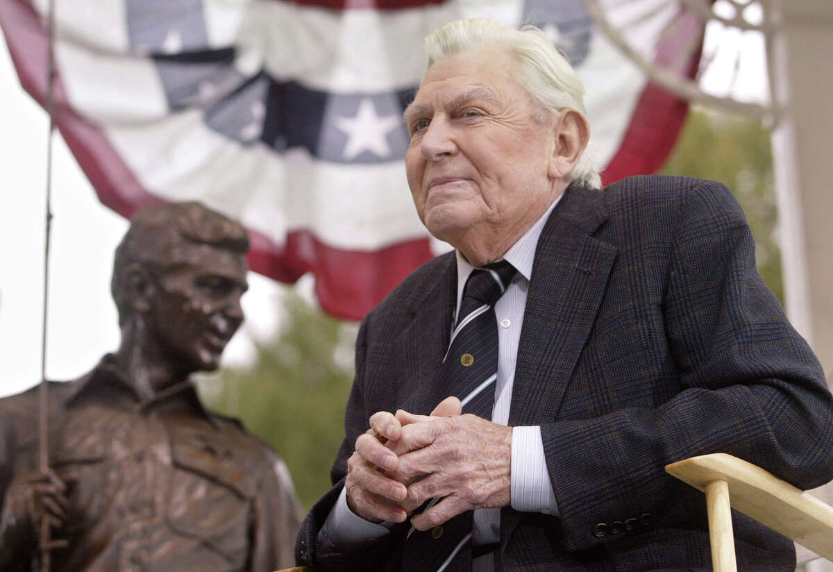 FILE - This Oct. 28, 2003 file photo shows actor Andy Griffith sitting in front of a bronze statue of Andy and Opie from the "Andy Griffith Show," after the unveiling ceremony in Raleigh, N.C. Griffith, whose homespun mix of humor and wisdom made "The Andy Griffith Show" an enduring TV favorite, died Tuesday, July 3, 2012 in Manteo, N.C. He was 86. (AP Photo/Bob Jordan, File)