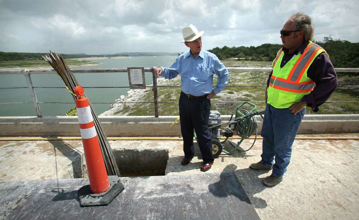 Bexar County Judge Nelson Wolff, left, asks Kris Roberson, Senior Engineering Technician for San Antonio River Authority, about the "anchors" installed at the construction project at the Medina Lake Dam which is reinforcing the structure, Monday, July 2, 2012.