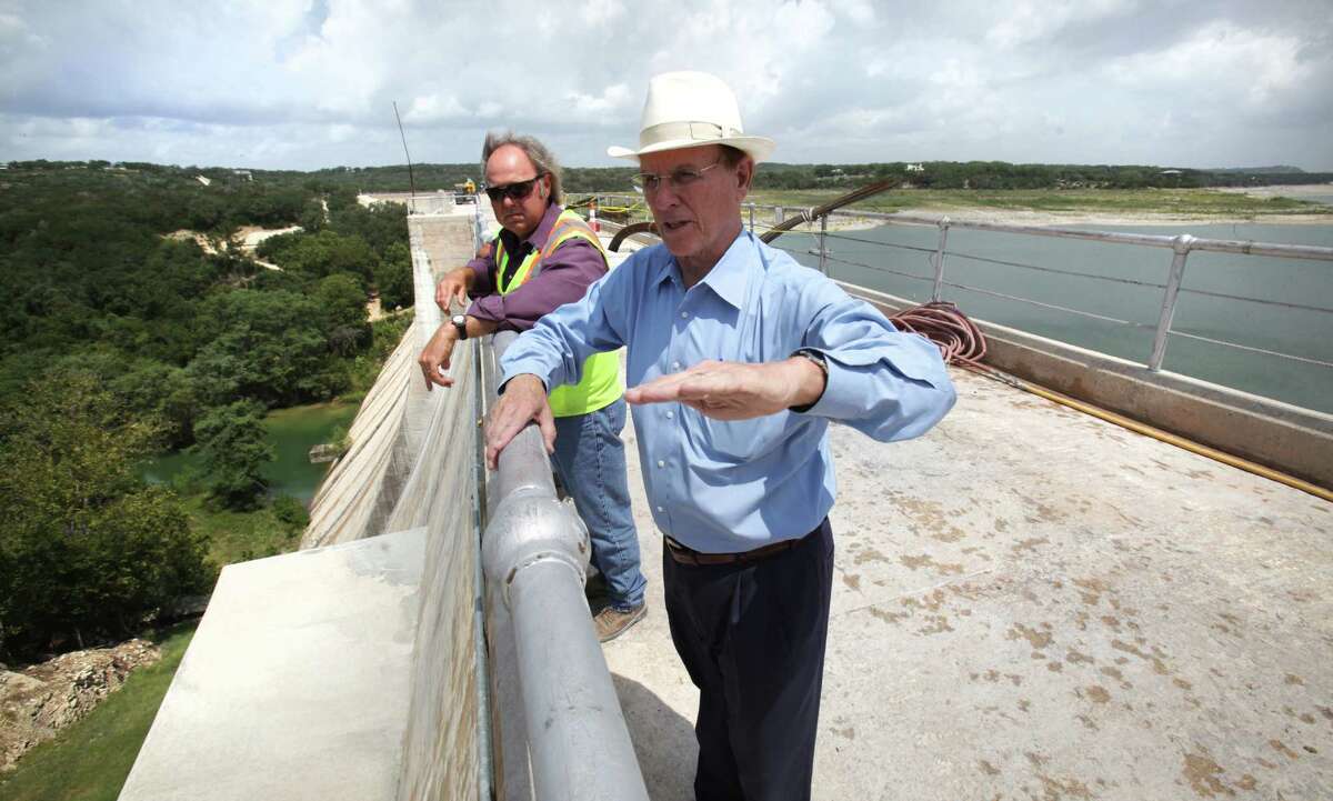 Bexar County Judge Nelson Wolff, right, and Kris Roberson, Senior Engineering Technician for San Antonio River Authority, discuss repairs to the Medina Lake Dam which is reinforcing the structure, Monday, July 2, 2012.
