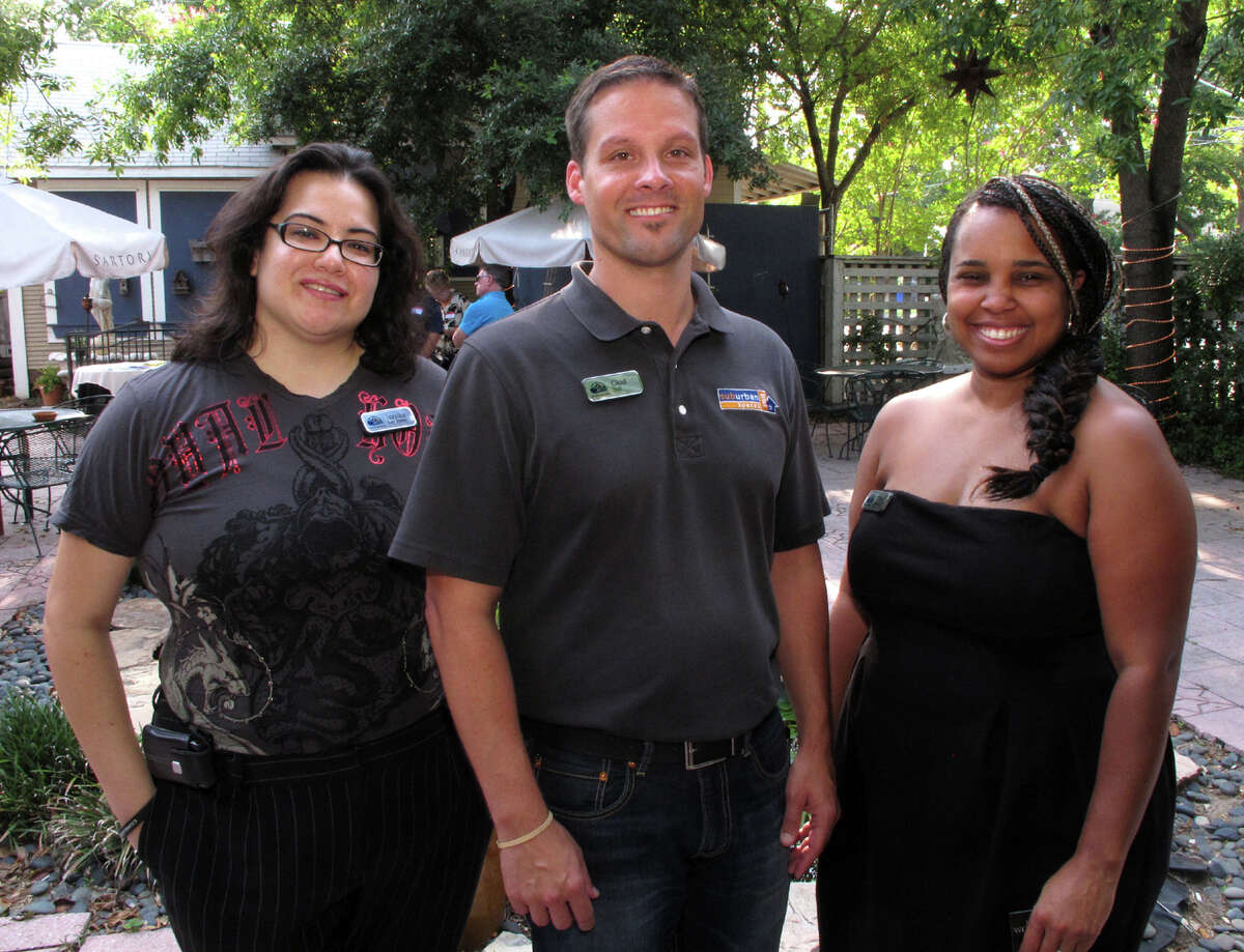 Board member Jezzika Lee Perez, from left, president Chad Nall and board member Tonya Perkins gather at the Lesbian, Gay, Bisexual and Transgender Chamber of Commerce mixer at the Candlelight Coffee House.