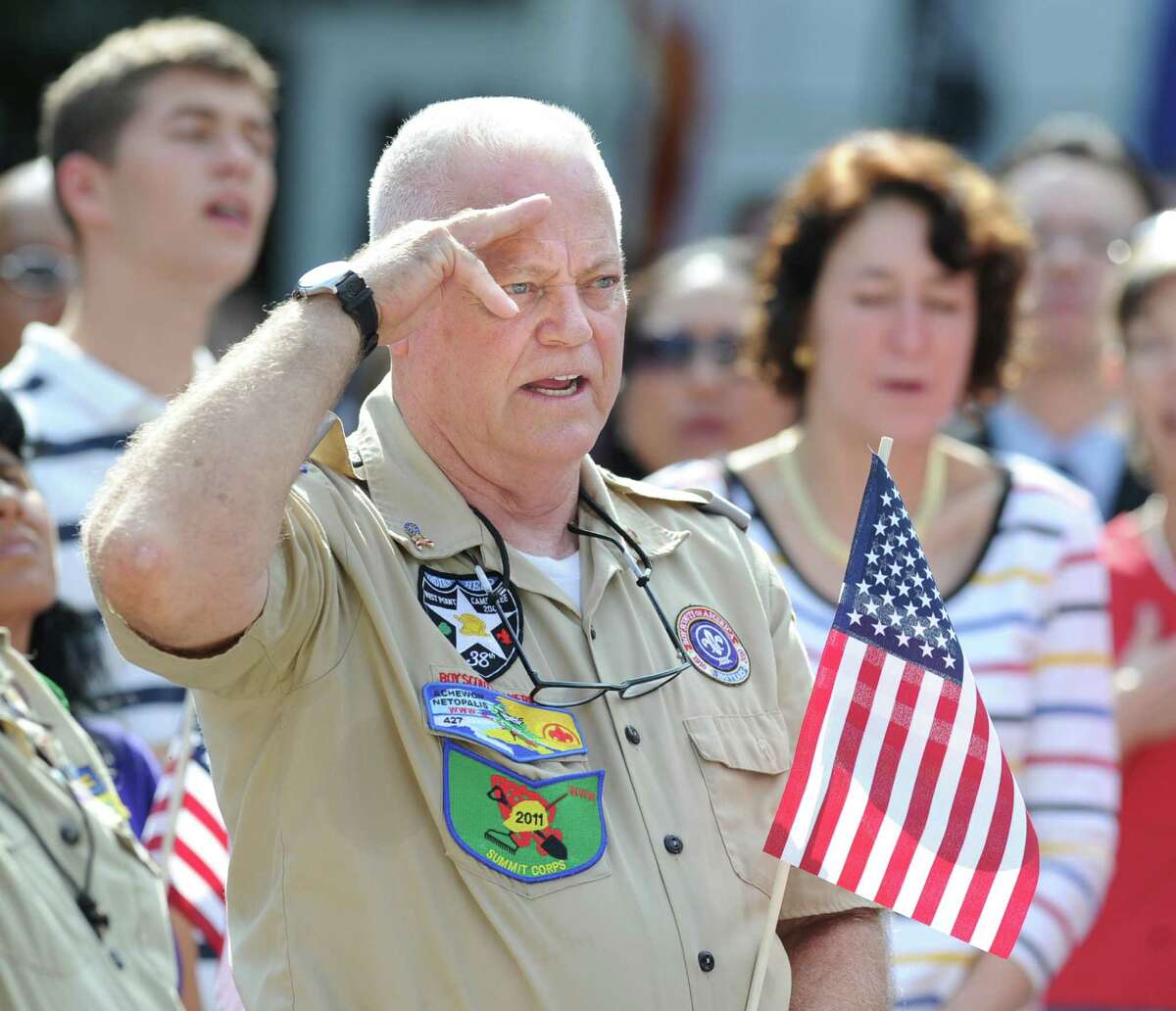 Boy Scout Troop 35 leader Rich Rooney of Greenwich salutes the American flag during the Fourth of July ceremony at Greenwich Town Hall, Wednesday morning, July 4, 2012.