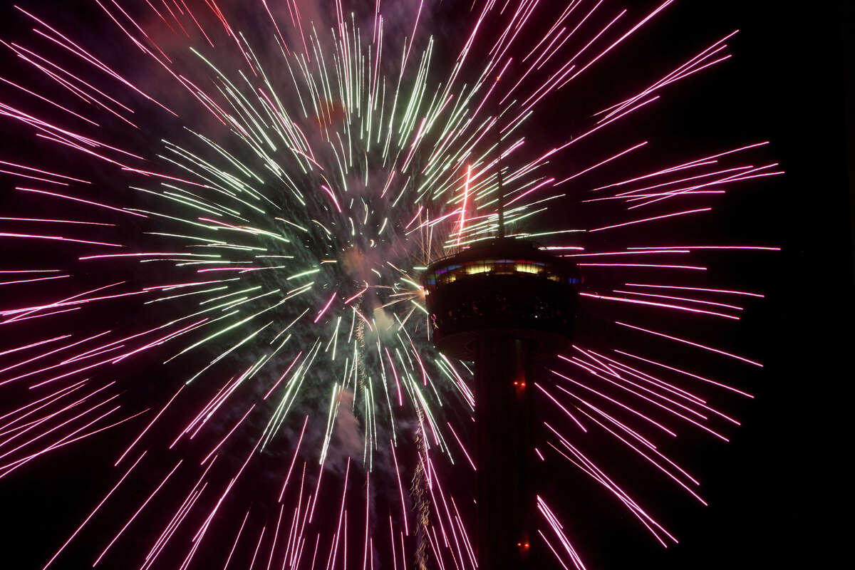 Fireworks burst next to the Tower of the Americas during the Stars & Stripes over San Antonio Inaugural event on Wednesday, July 4, 2012.