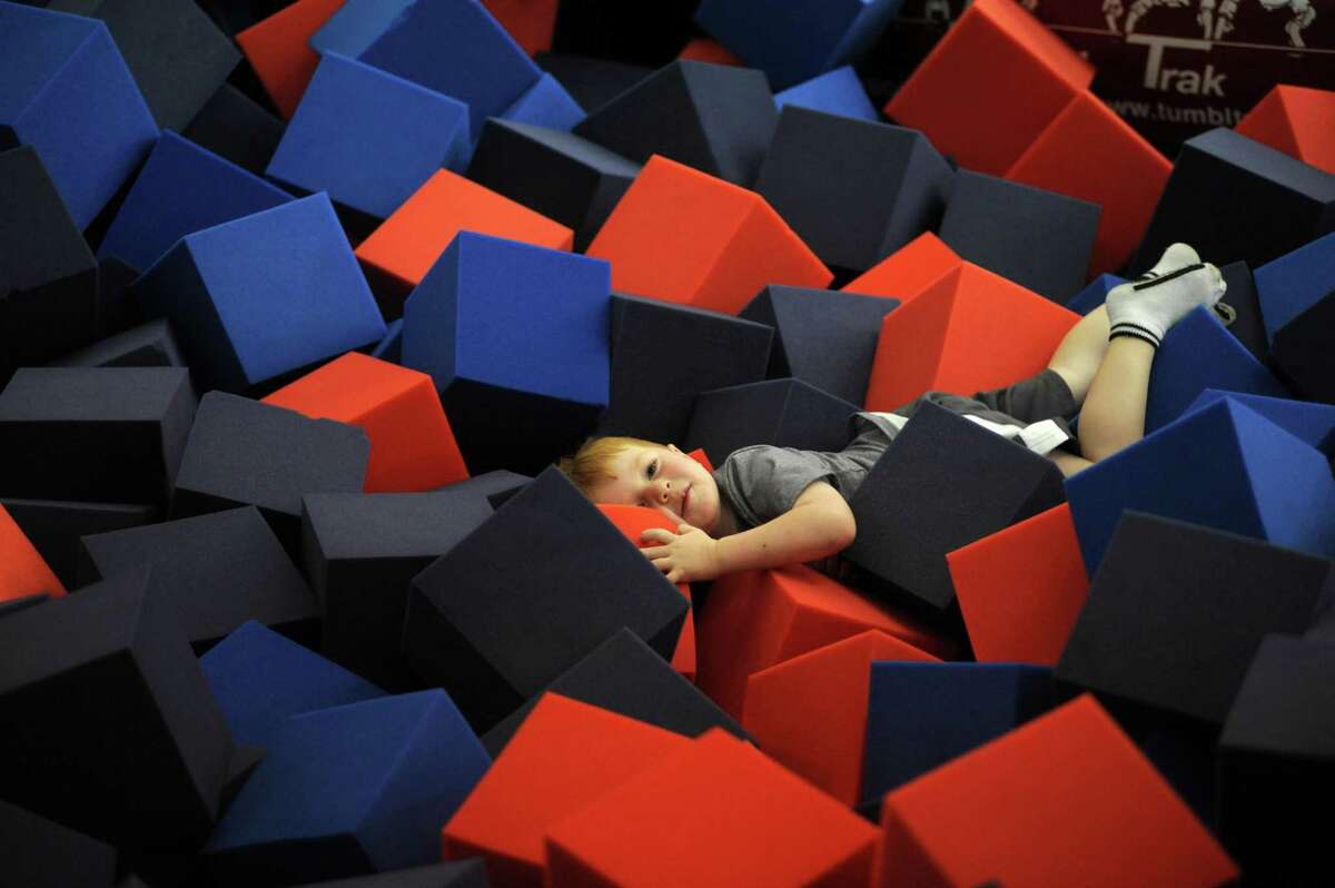 Drew Samaan, son of Chelsea Piers Connecticut Executive Director Mollie Marcoux, plays in one of the deep foam training pits in the gymnastics center at the facility.