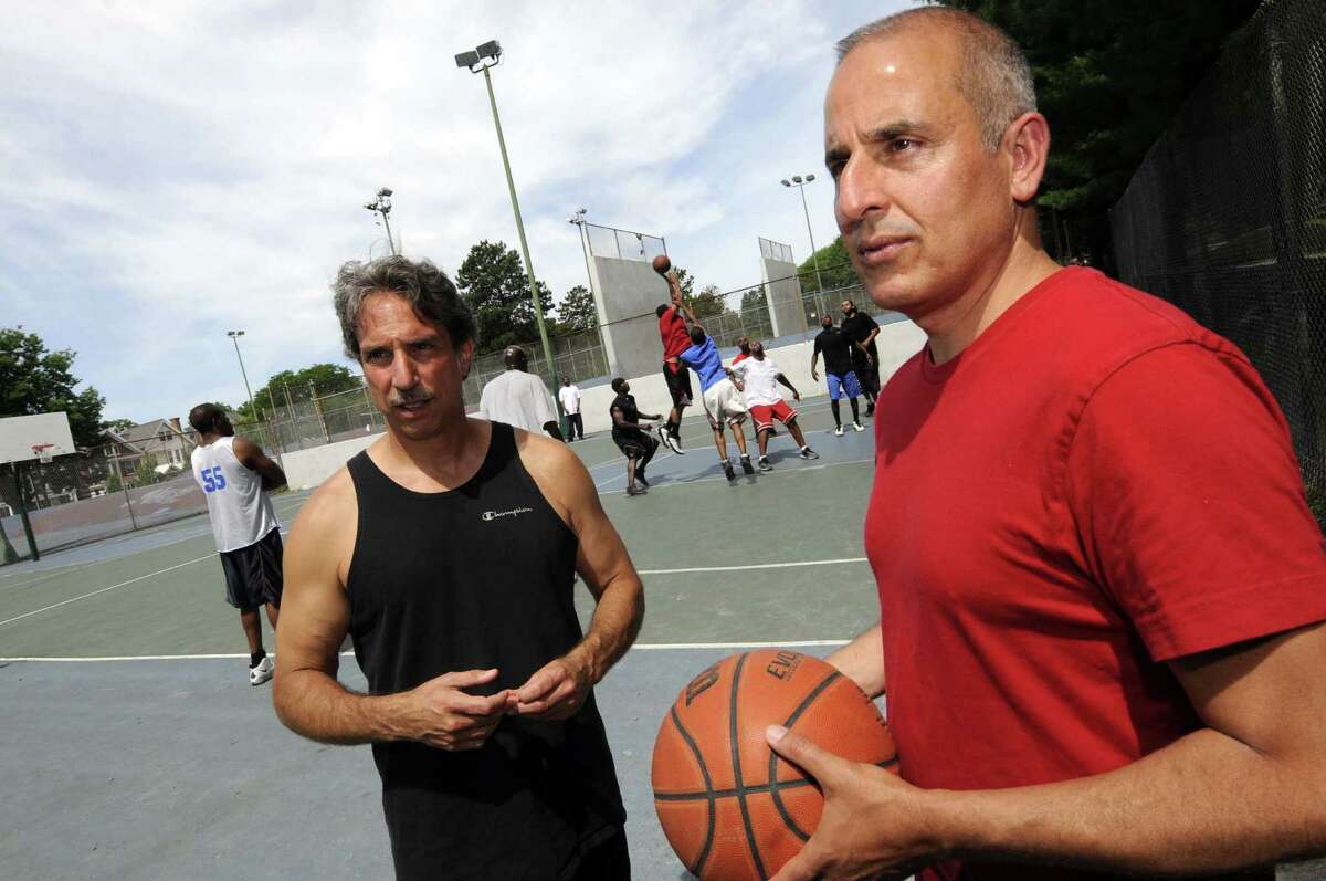 Basil Anastassiou, left, and Paul Kentoffio have made a documentary called "Ballin' at the Graveyard" about the 40-year-old game of pickup basketball played every weekend on the courts at Washington Park in Albany N.Y. Saturday June 30, 2012. (Michael P. Farrell/Times Union)