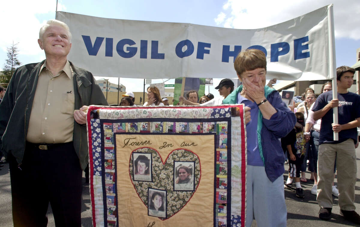 Francis and Carole Carrington hold up a banner with photos of their daughter Carole Sund, granddaughter Julie Sund and family friend Silvina Pelosso, during a march and rally in downtown Modesto, Calif., Saturday, April 26, 2003, for victims of violent crimes, in the wake of the Laci Peterson murder. The three were murdered at Yosemite National Park in 1999 by Cary Stayner, who was sentenced to death for the crime.