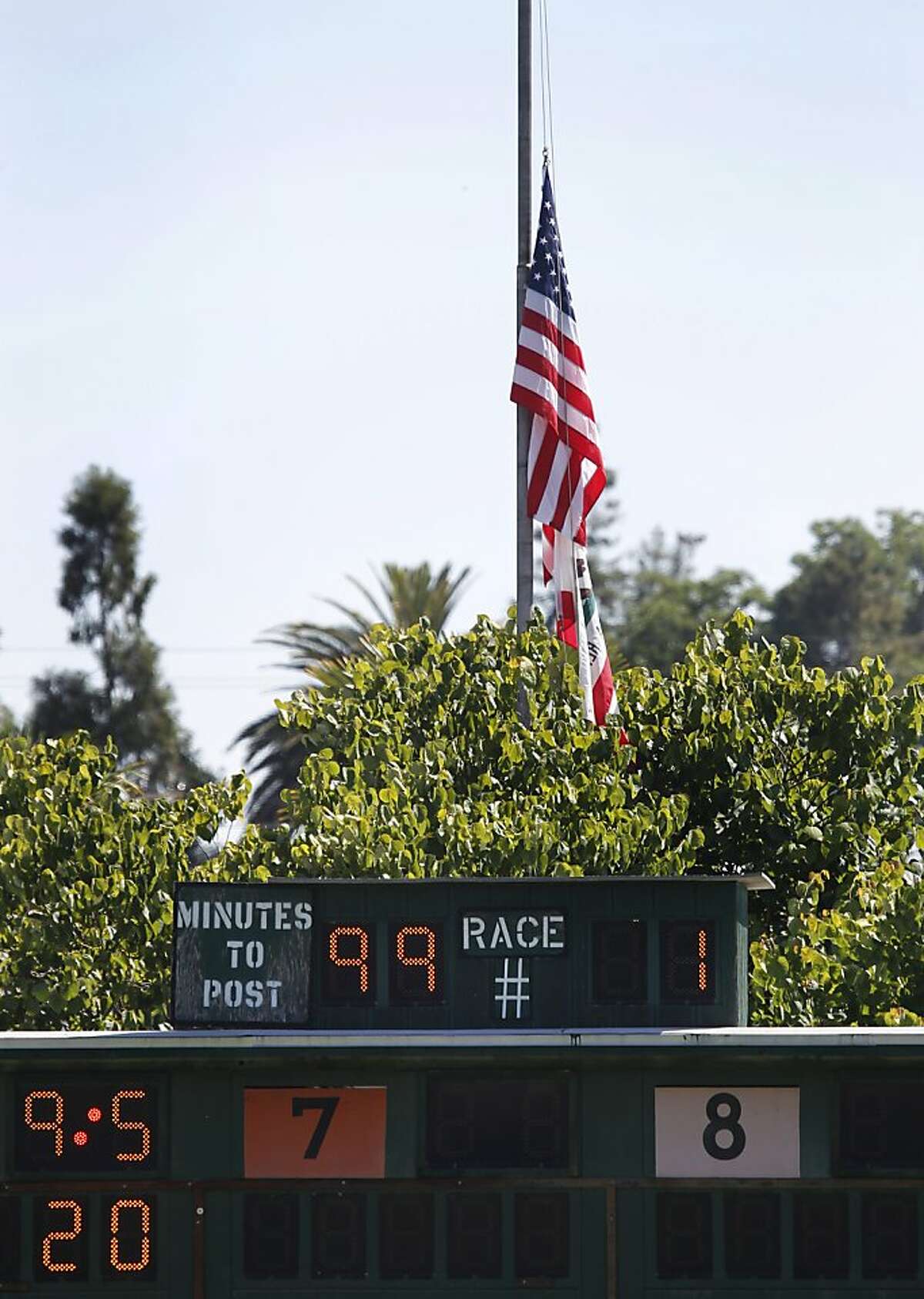 Flags are flown at half mast at the Alameda County Fair in Pleasanton, Calif. on Friday, July 6, 2012, one day after jockey Jorge Herrera died when he was thrown from Morito during the final race.
