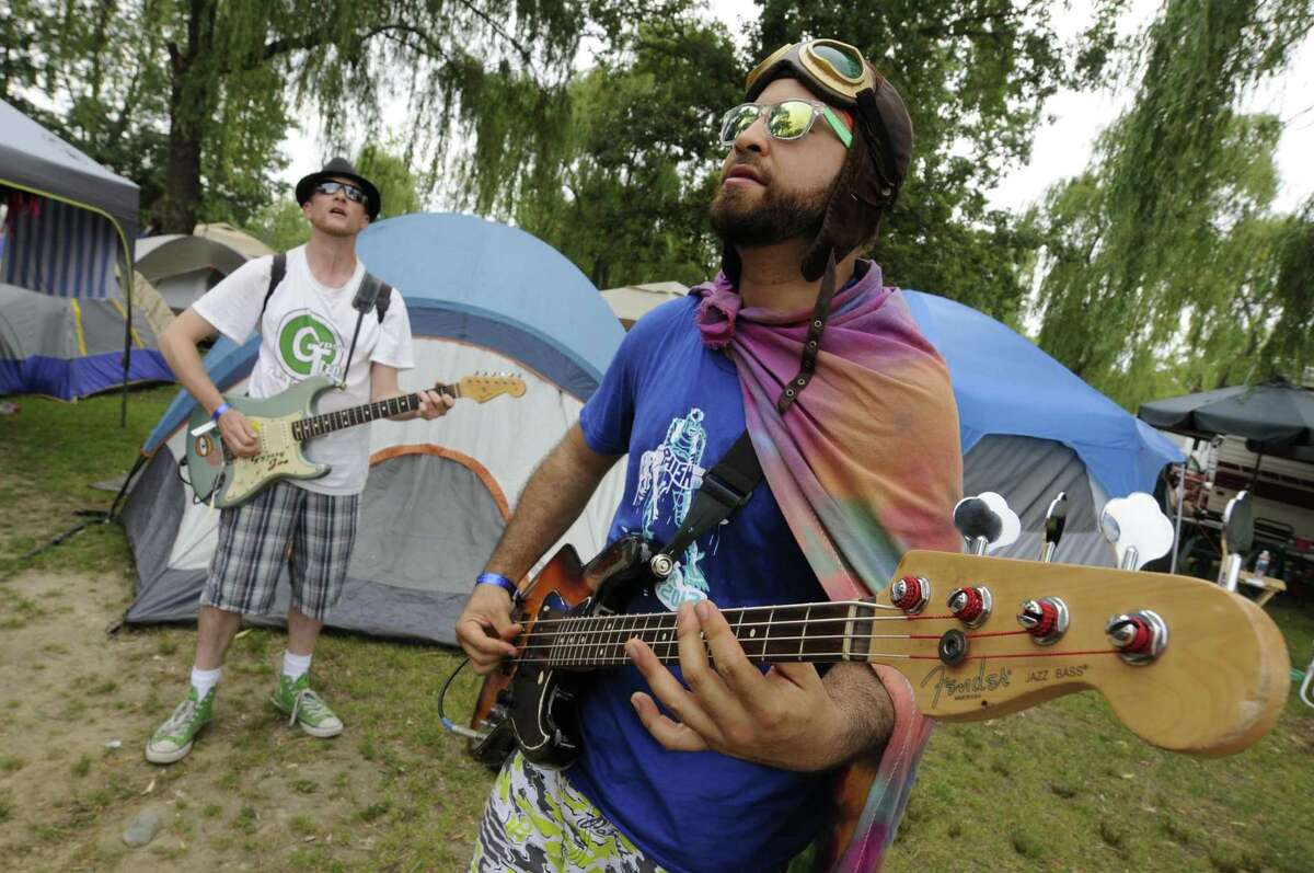 Phish fans Glue Lantigua, right, and Gypsy Joe Hocking perform music for other campers and Phish fans at Lee's Park campground in Saratoga Springs N.Y. Saturday July 7, 2012. (Michael P. Farrell/Times Union)