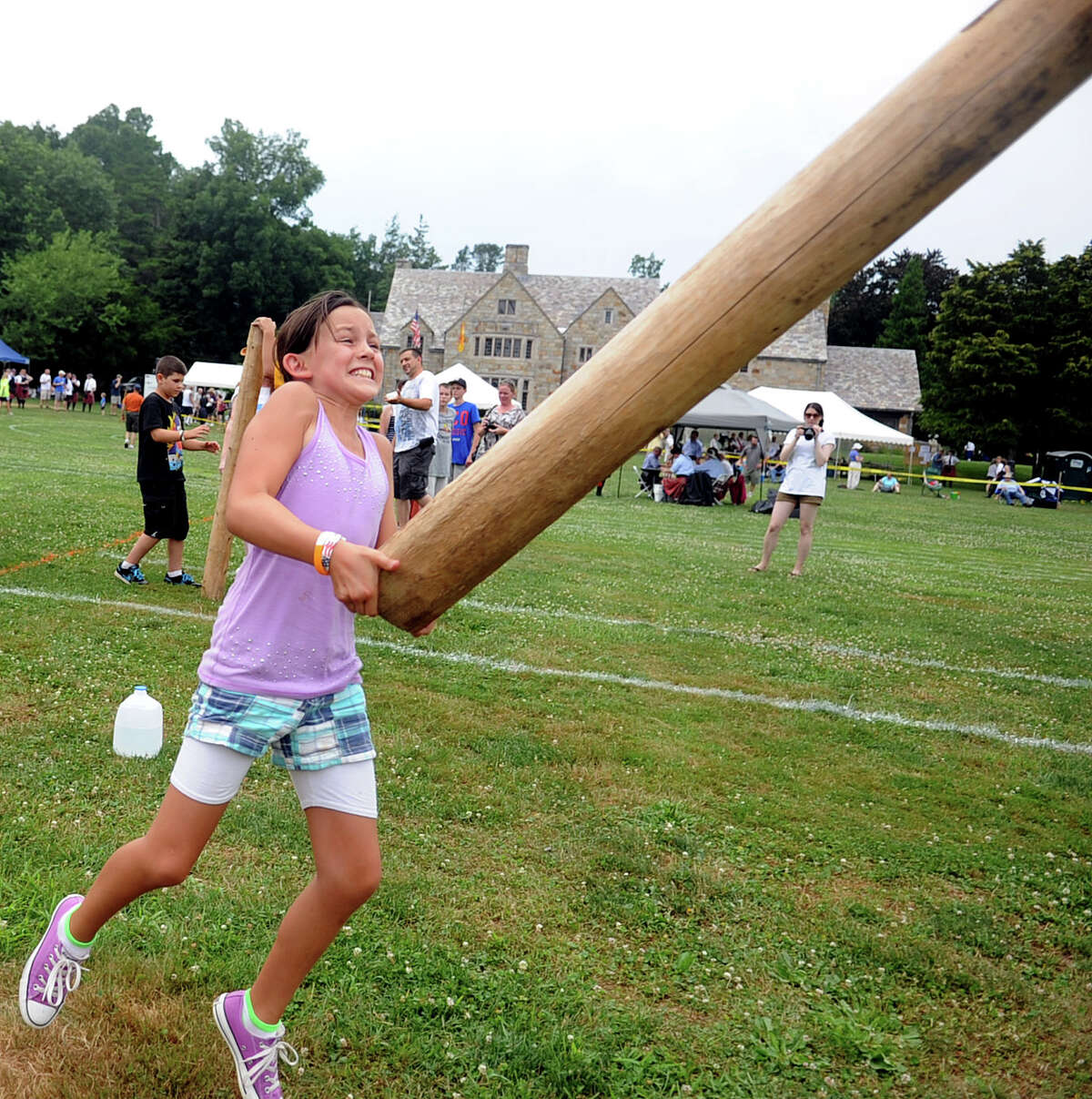 Isabella Fragomeli, 10, of Pleasanton, Calif., participates in the children's Caber Toss during the Round Hill Highland Games at Cranbury Park in Norwalk on Saturday, July 7, 2012.