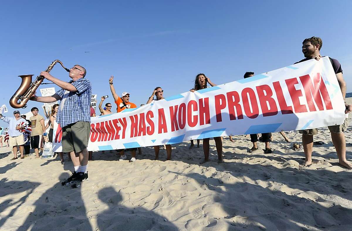 David Intrator plays the saxophone as protestors from MoveOn.org, the Occupy Movement and the Long Island Progressive demonstrate against a fundraiser for Republican presidential candidate Mitt Romney on the beach in front of the home of industrial billionaire David H. Koch on Sunday, July 8, 2012, in Southampton, N.Y. Romney would be among the nation's richest presidents if elected. He made his fortune at Bain Capital, a Boston-based private equity. (AP Photo/Kathy Kmonicek)