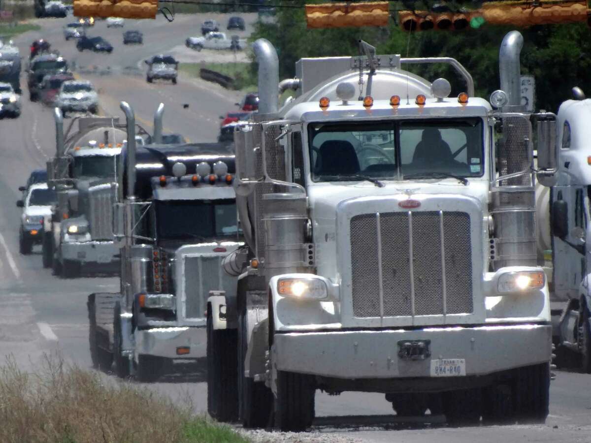 Trucks involved in the Eagle Ford Shale energy industry make their way along Highway 181 in Kenedy last Friday.