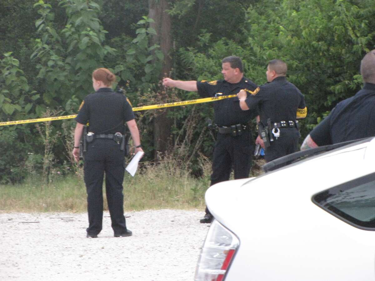 San Antonio police investigate the scene where a woman's nude body was apparently dumped several days ago. Neighbors reported a strong odor Sunday evening, when police found the woman's decomposing body.