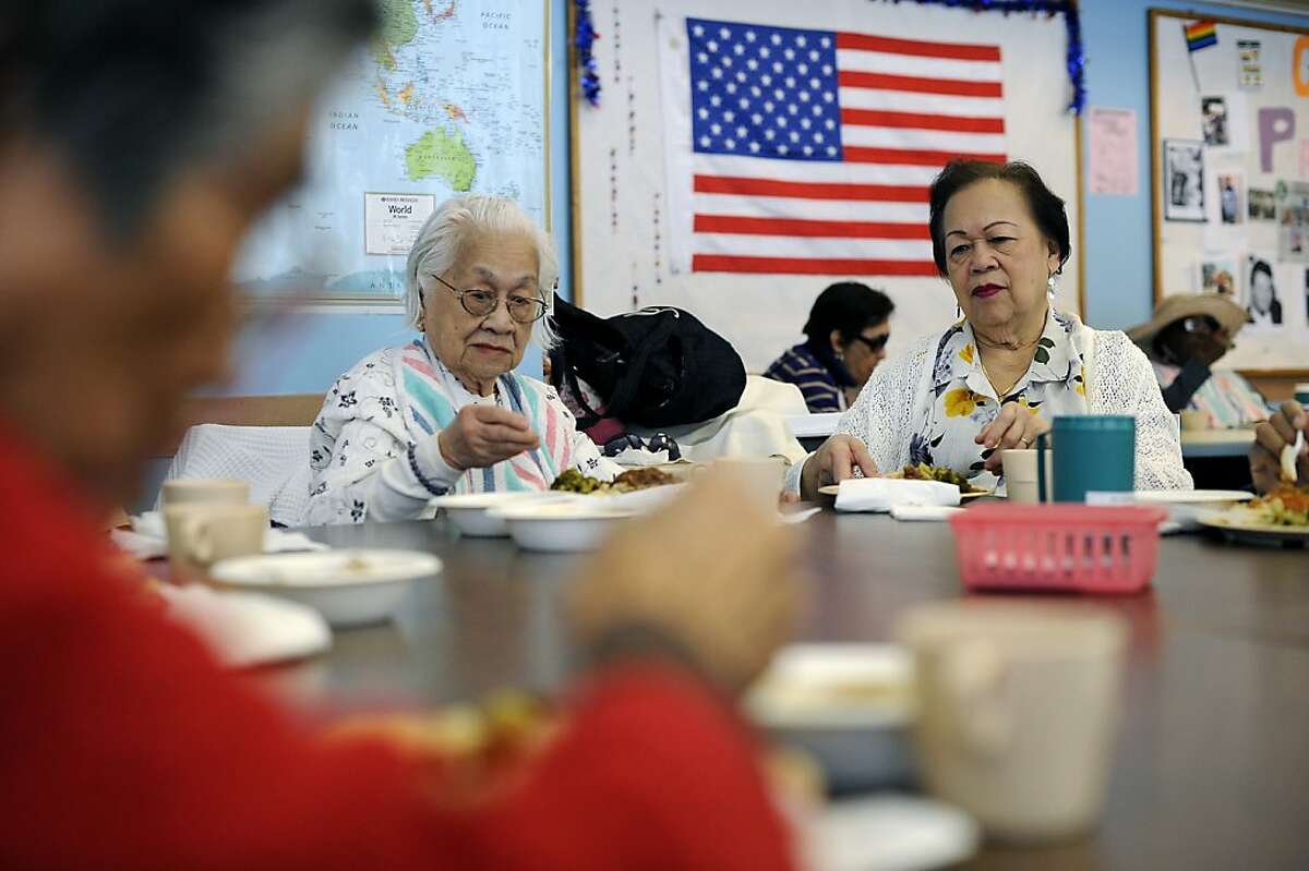 Hope Olson (right) and sister Fe Garcia have lunch at the Adult Day Health Care Center in San Francisco.