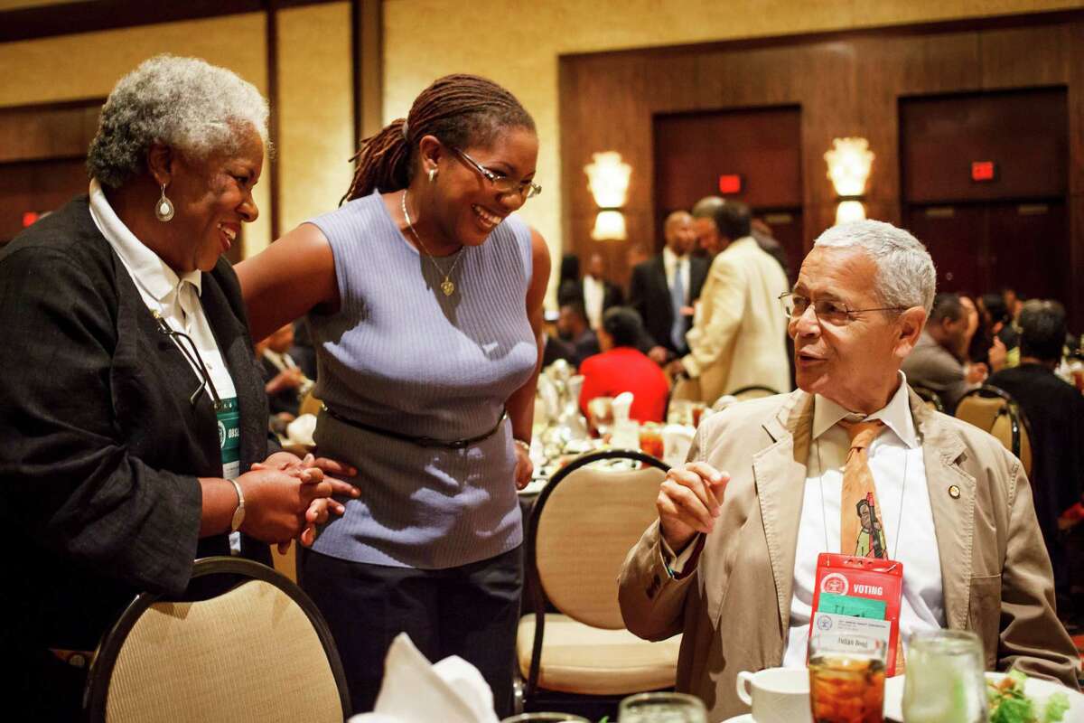 Etta Hill, left, and daughter Cassandra Hill talk to social activist and civil rights leader Julian Bond during a luncheon Monday at the 103rd NAACP Convention.