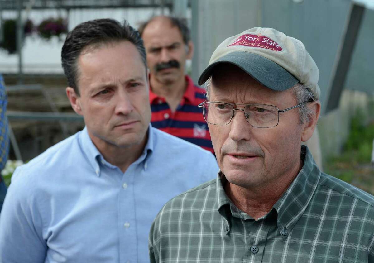 Assemblyman Pete Lopez, left listens to farm owner Richard Ball as he discusses the proposed pipeline in Schoharie County July 10, 2012 at a press conference at his Schoharie Valley Farm in Schoharie, N.Y. (Skip Dickstein / Times Union)