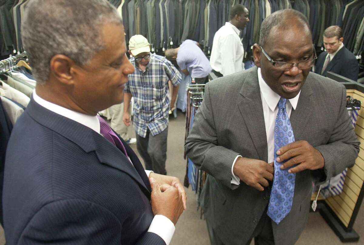Steve Cook, left, of Men's Wearhouse helps James Williams select a tie at Career Gear, which provides free suits to men who need them for job interviews. Cook is vice president of community relations and corporate giving for Men's Wearhouse.