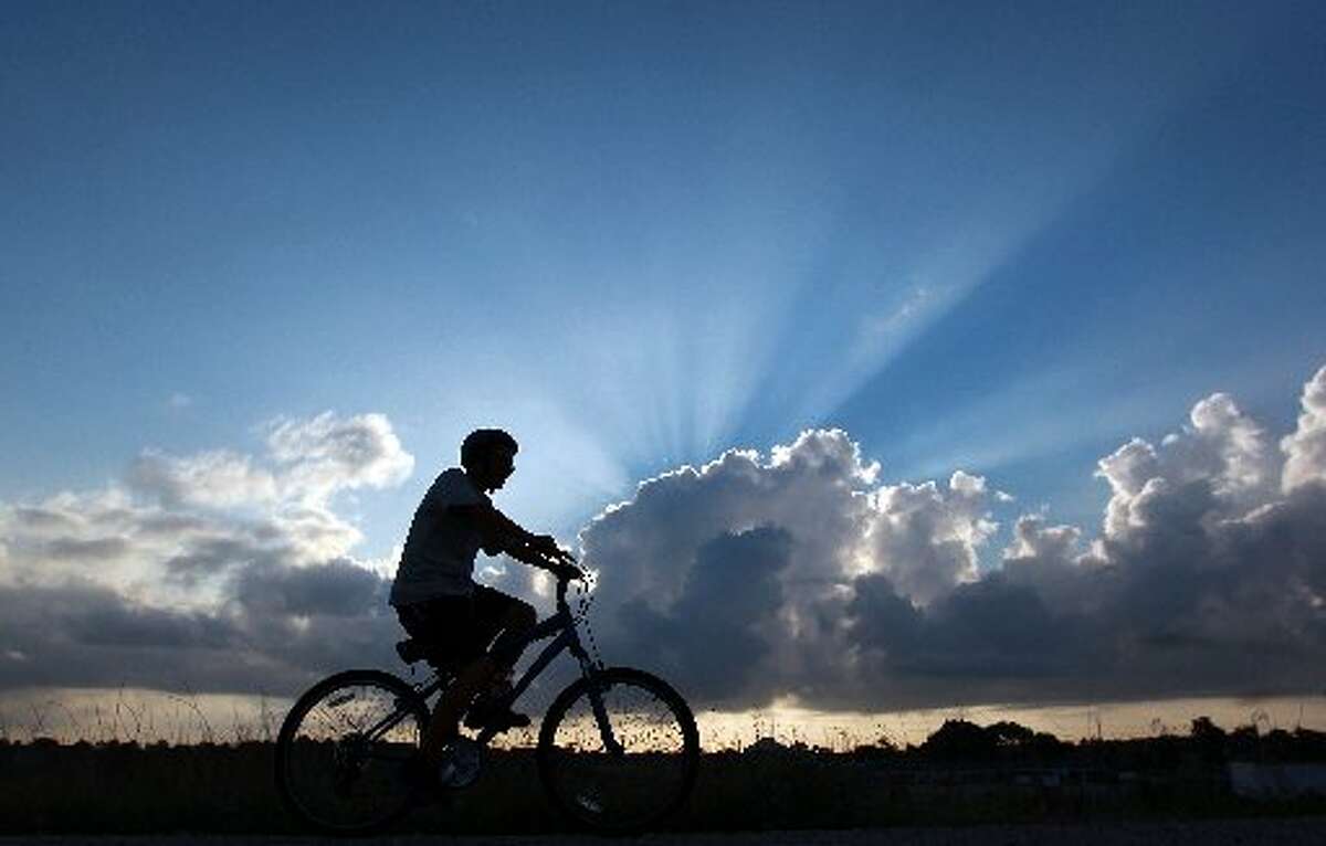 Cyclist, Mike Hallecook rides his bike along Barker Reservoir in George Bush Park where he said he rides two-to-three times a week Thursday, July 5, 2012, in Houston. "It's beautiful today, " Hallecook said of the weather. Johnny Hanson / Houston Chronicle )