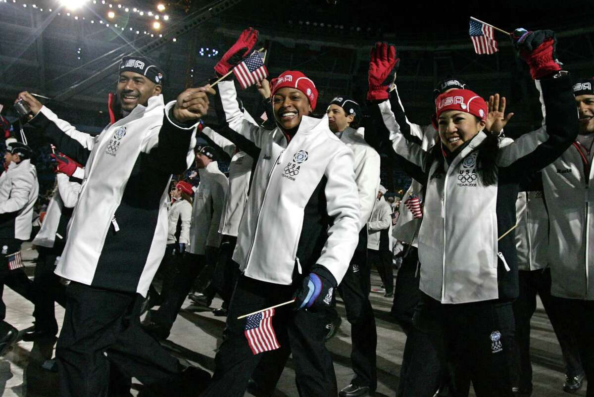 Michelle Kwan, right, and Vonetta Flowers, center, arrive with the United States team during the opening ceremony for the 2006 Winter Olympics in Turin, Italy, Friday, Feb. 10, 2006.