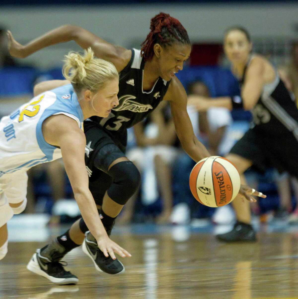 San Antonio Silver Stars' Danielle Robinson (13) steals the ball from Chicago Sky's Courtney Vandersloot during the first half of an WNBA basketball game, Wednesday, July 11, 2012, in Rosemont, Ill. (AP Photo/Charles Rex Arbogast)