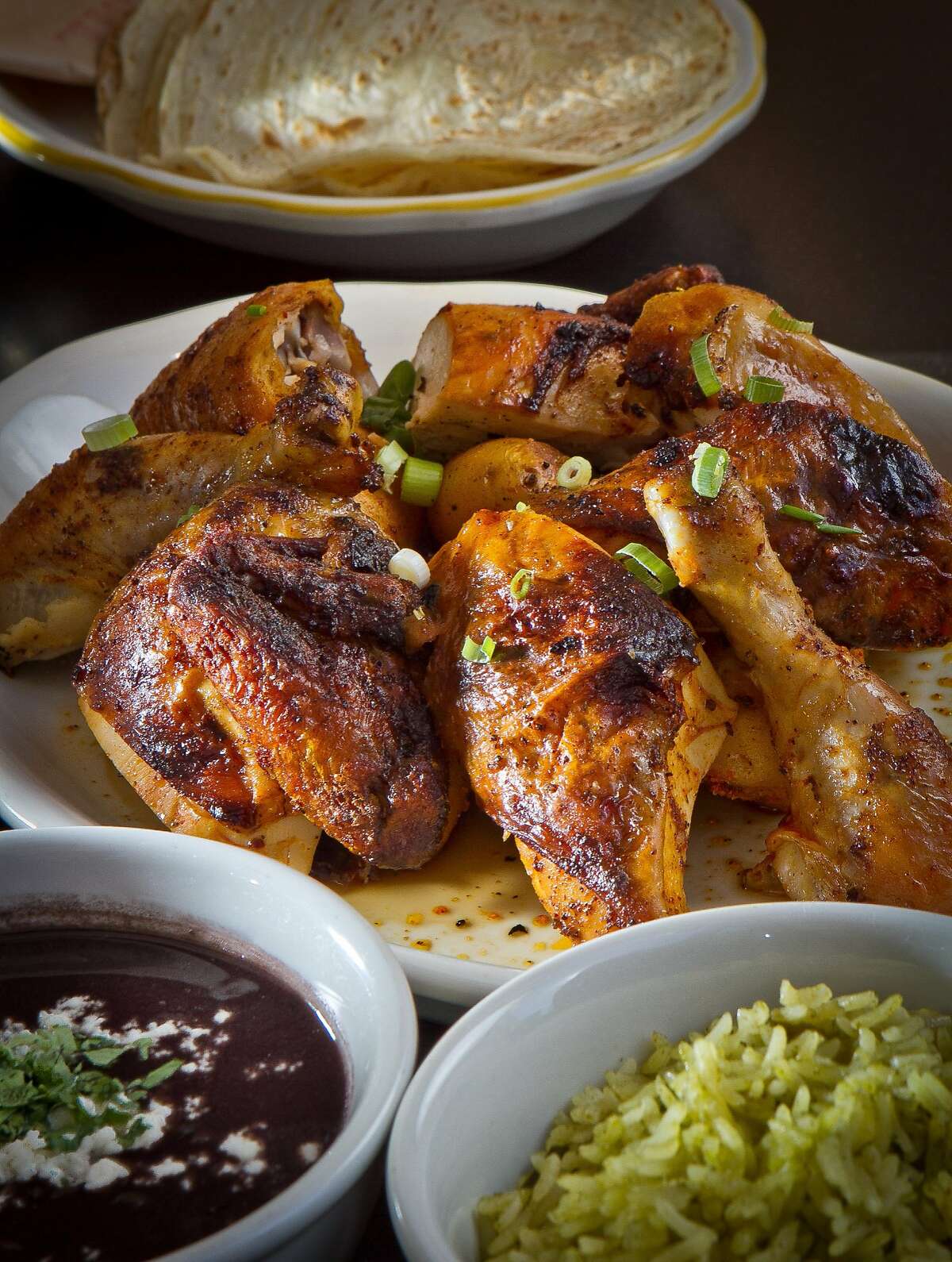 The Spit-Roasted Fulton Valley Chicken with Rice, Beans and Tortillas at Comal Restaurant in Berkeley, Calif., is seen on Tuesday, July 3rd, 2012.