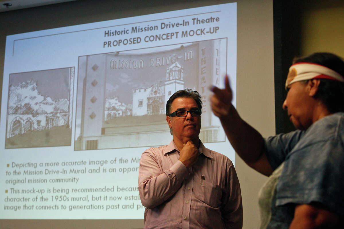 Diane Uriegas (right) voices her concerns to Felix Padrón, Director of the Office of Cultural Affairs for the City of San Antonio, center, and others in attendance at a public meeting for discussion on the Mission Drive-In marquee and mural restoration at the Mission Branch Library in San Antonio on Tuesday, July 10, 2012.