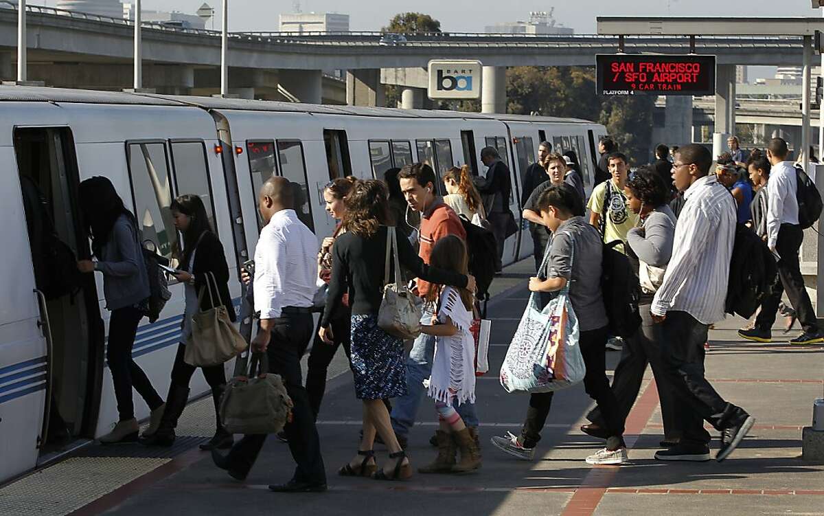 In this file photo, commuters board a San Francisco-bound train at the MacArthur BART station in Oakland. BART is recovering from major system-wide delays Thursday morning after a maintenance vehicle broke down early this morning between the MacArthur and 19th Street stations.