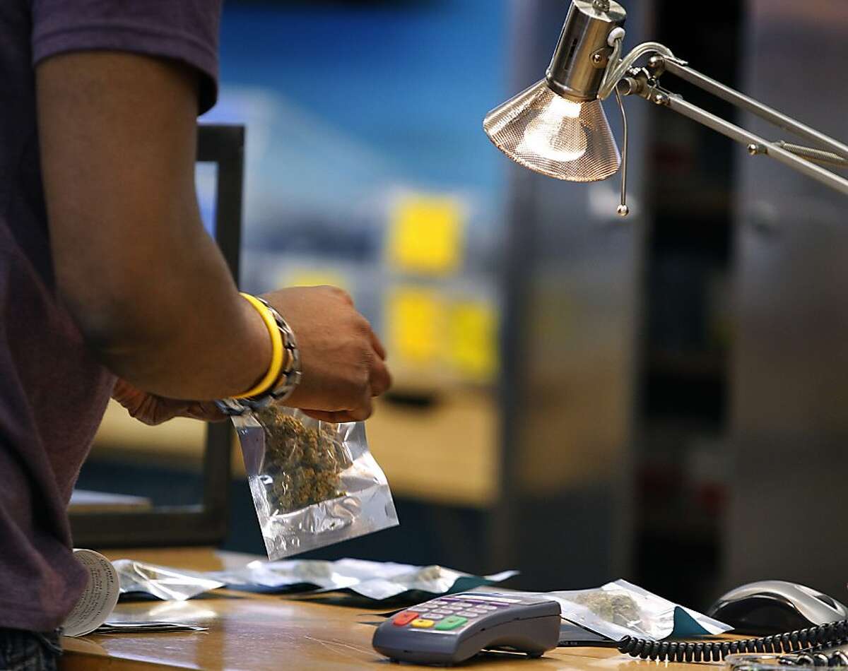 A patient purchases medical marijuana at the Harborside Health Center dispensary in Oakland, Calif. on Thursday, July 12, 2012. The Department of Justice served notice that it will seize the assets and shut down Harborside within 20 days.