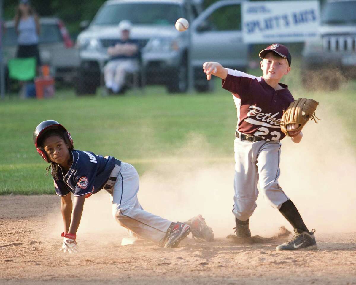Bethel's Kyle Platt gets the force at second but is unable to complete the double play against Danbury in the Cal Ripken 10-year-old state tournament championship game Thursday at Mitchell Park in Bethel.