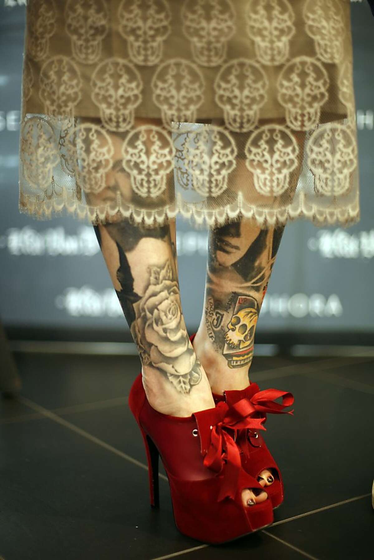 Kat Von D shows off her tatooed legs at a show of here artwork in Portland, Ore. (Photo by Jackie Butler/Getty Images for Sephora)