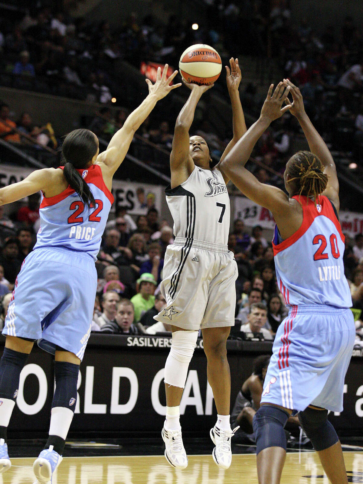 Silver Stars' Jia Perkins shoots between Dream's Armintie Price and Dream's Sancho Lyttle during first half action Friday, July 13, 2012 at the AT&T Center.