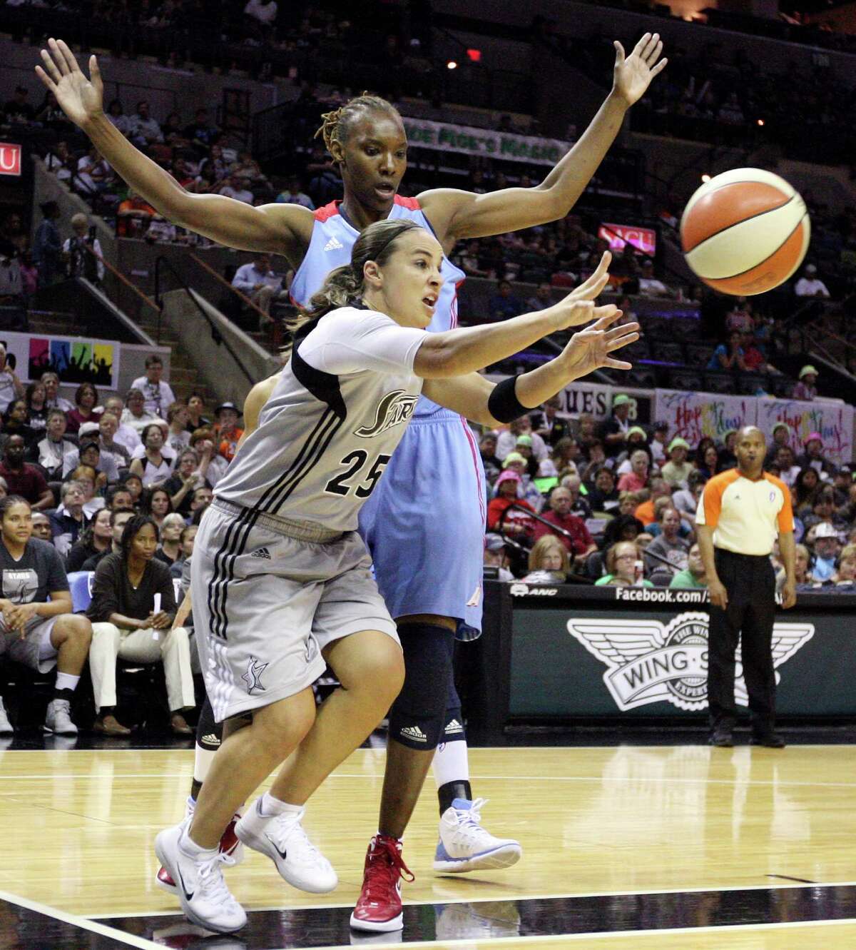 Silver Stars' Becky Hammon passes around Dream's Sancho Lyttle during first half action Friday, July 13, 2012 at the AT&T Center.
